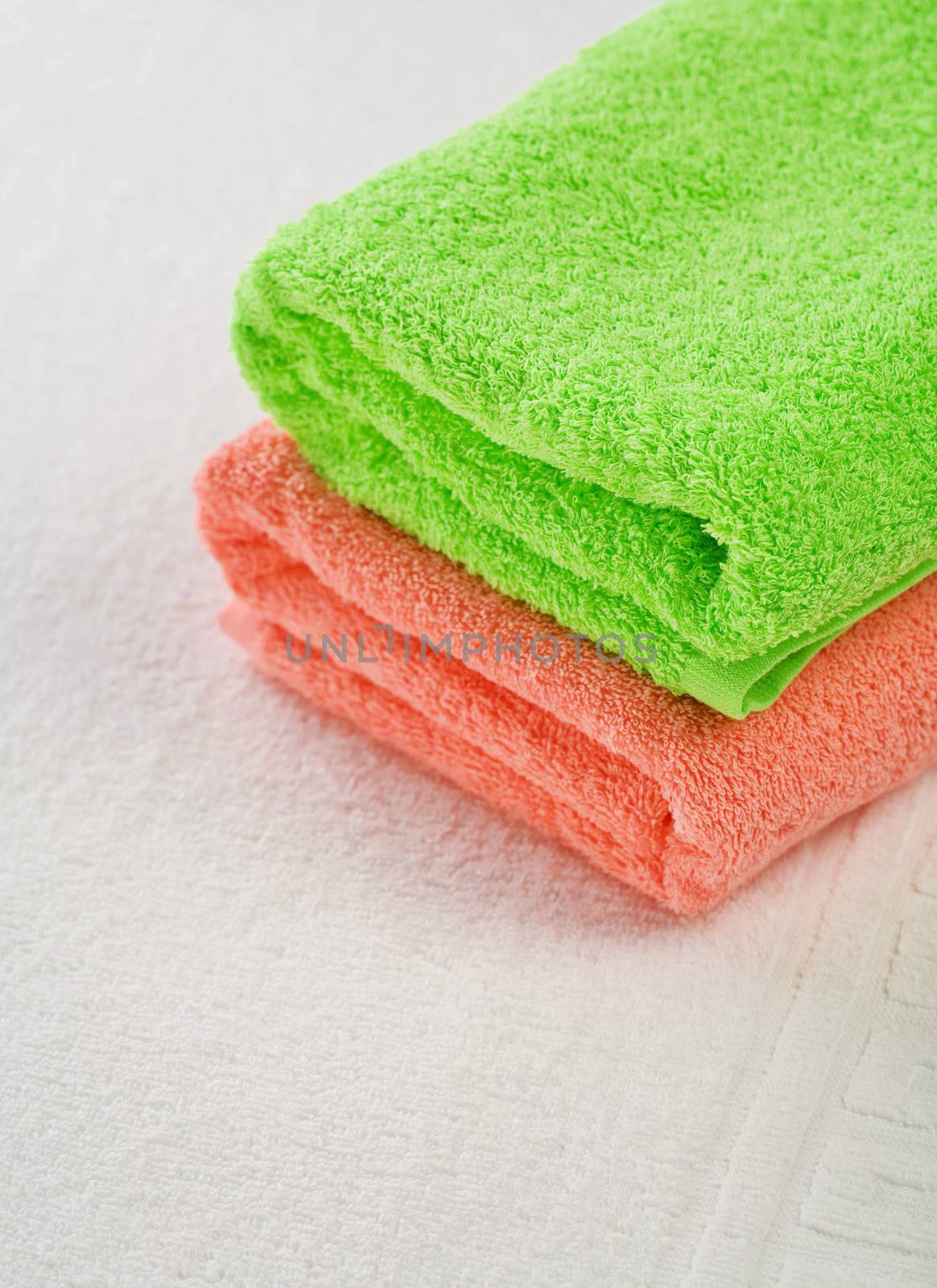 pink and green towels on white background