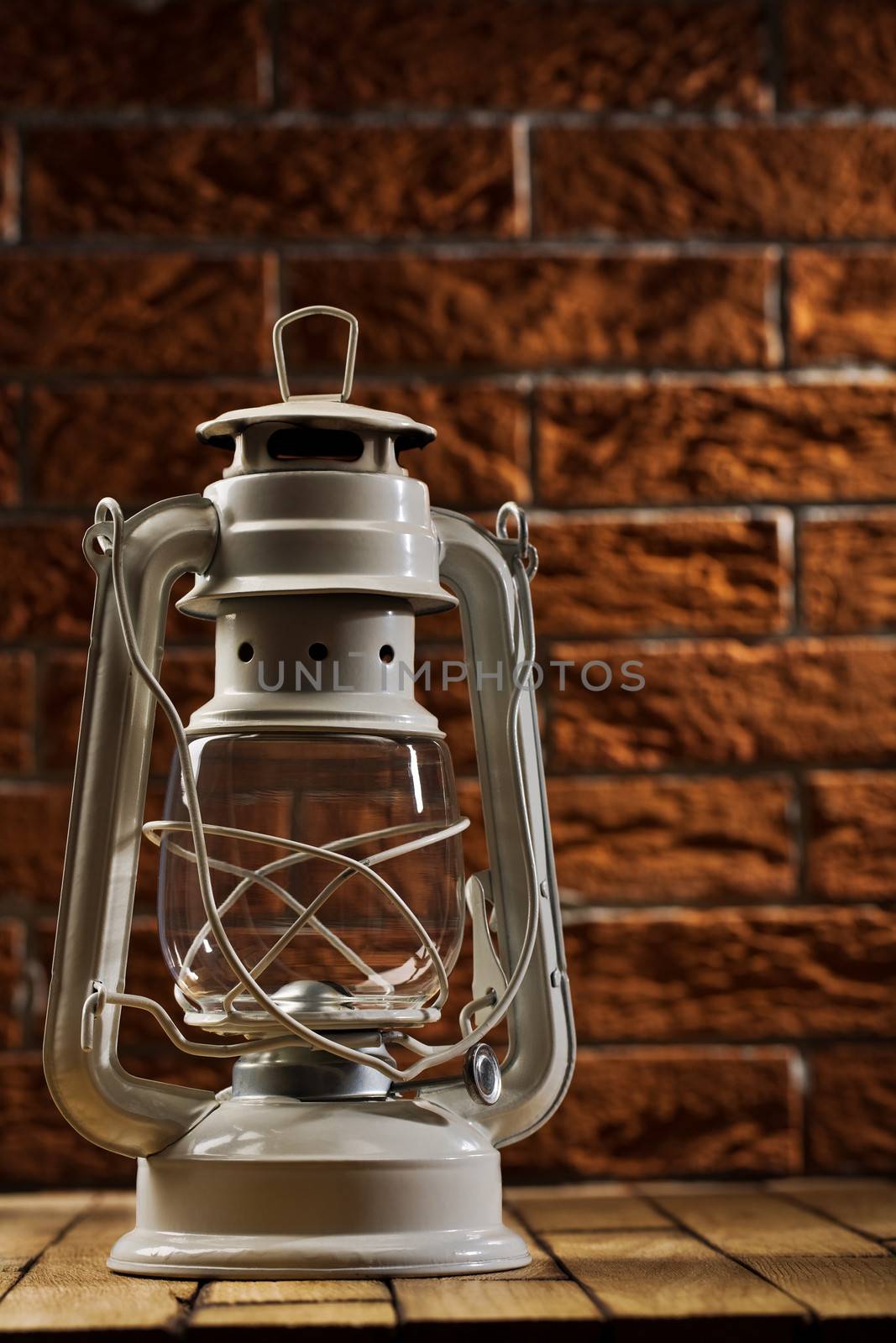 white kerosene lamp on background of the brickwall