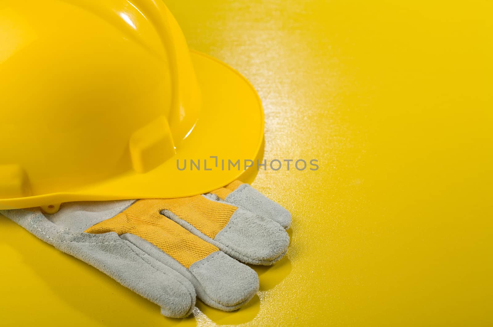 yellow hardhat on glove