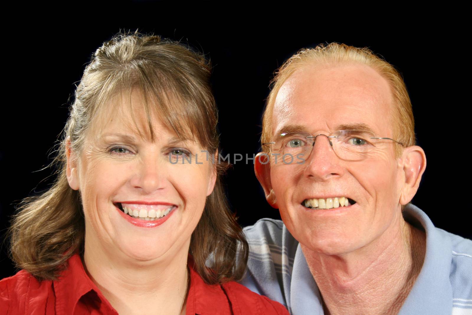 Middle aged couple together smiling. 