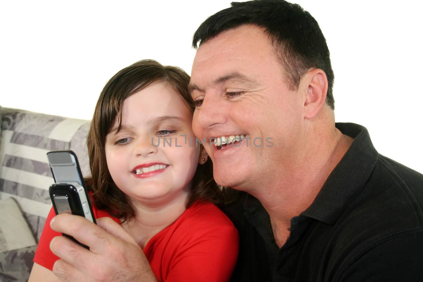 Father and young daughter play a game on her cell phone.