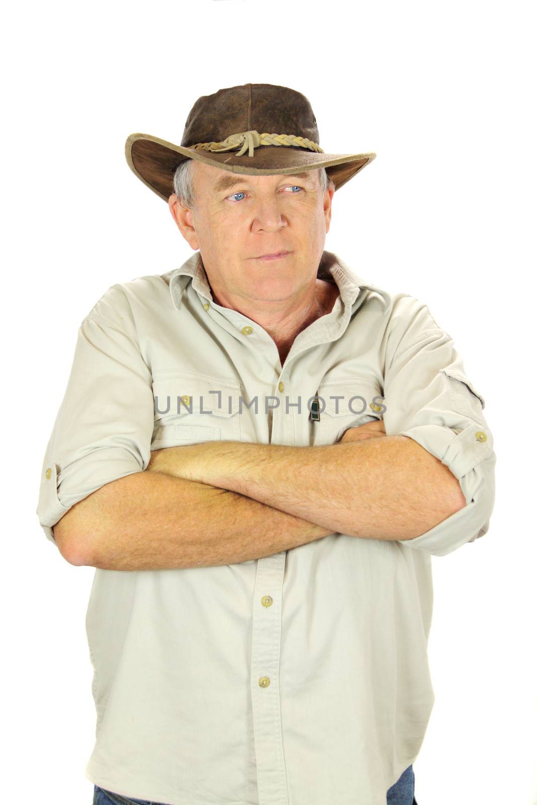 Casual middle aged man standing with arms crossed with a hat.