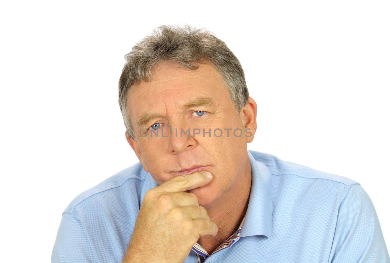 Casual middle aged man with hand on chin with a concerned look.