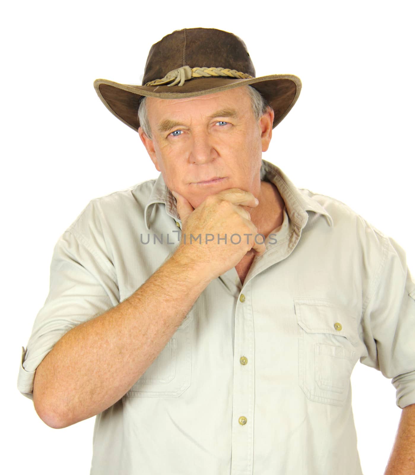 Middle aged man in leather hat with hand on chin.