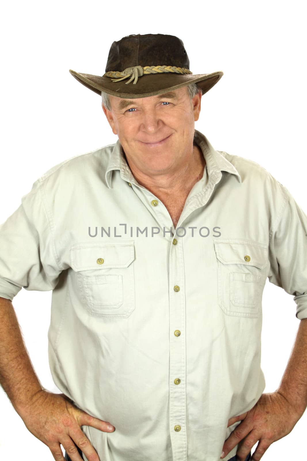 Middle aged man with in a leather hat with hands on hips.