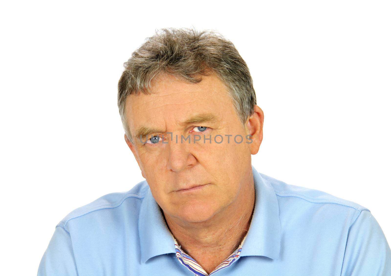 Brooding middle aged man looks directly to camera.