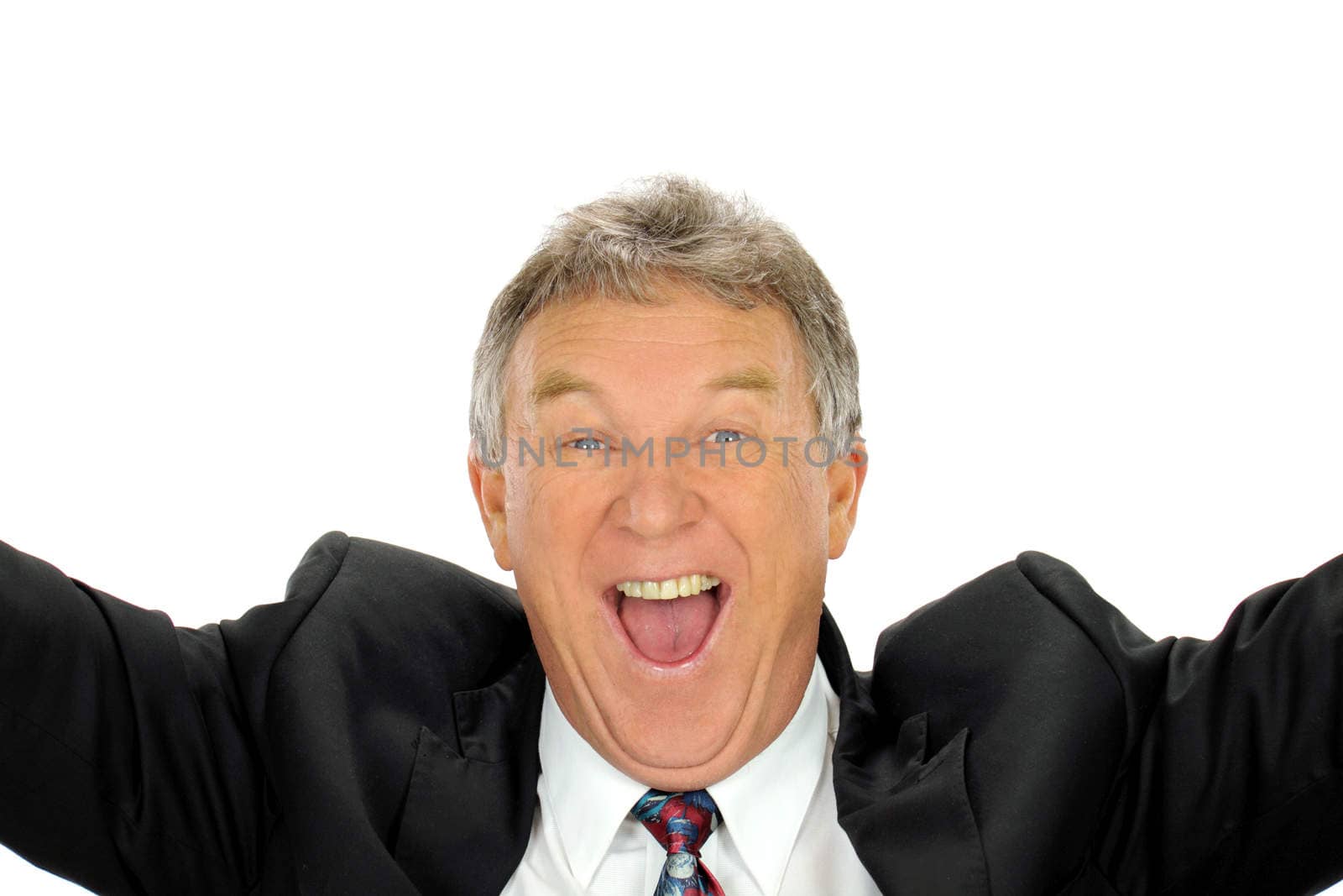 Ecstatic middle aged businessman throws his arms into the air with delight.