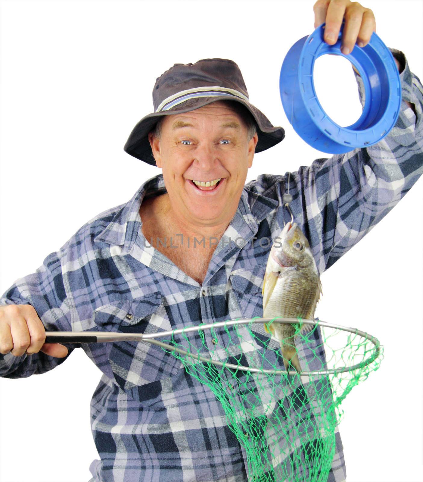 Happy middle aged fisherman holds up the fish he has just caught.