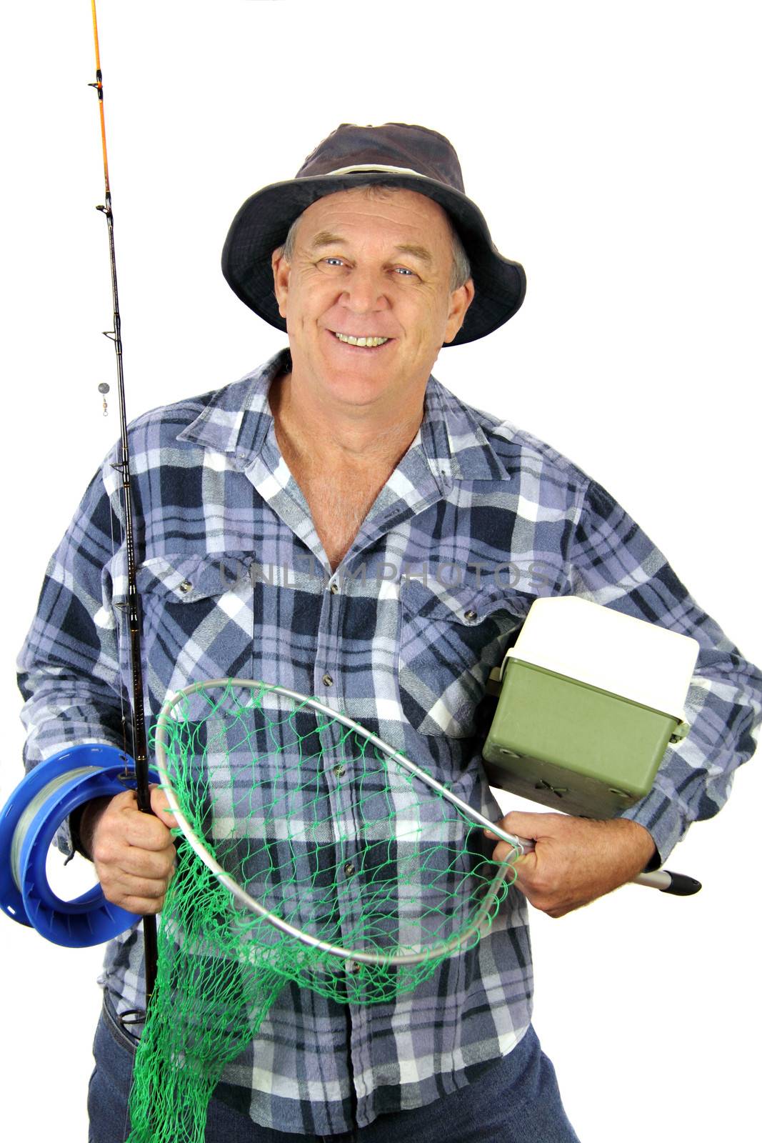Middle aged fisherman carrying all the gear for a day's fishing.