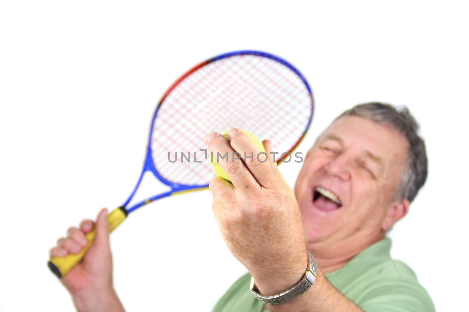 Middle aged man about to serve a tennis ball.