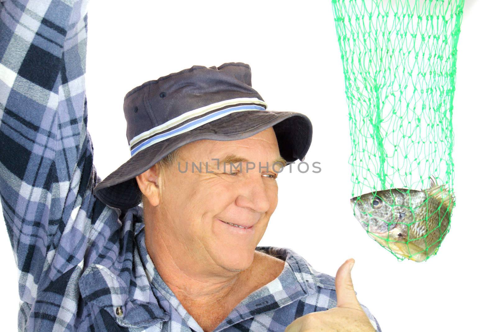 Proud fisherman holds his catch up in a net with a thumbs up.