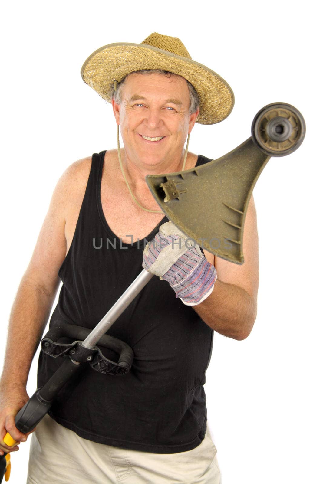 Smiling middle aged gardener holding a whipper snipper.
