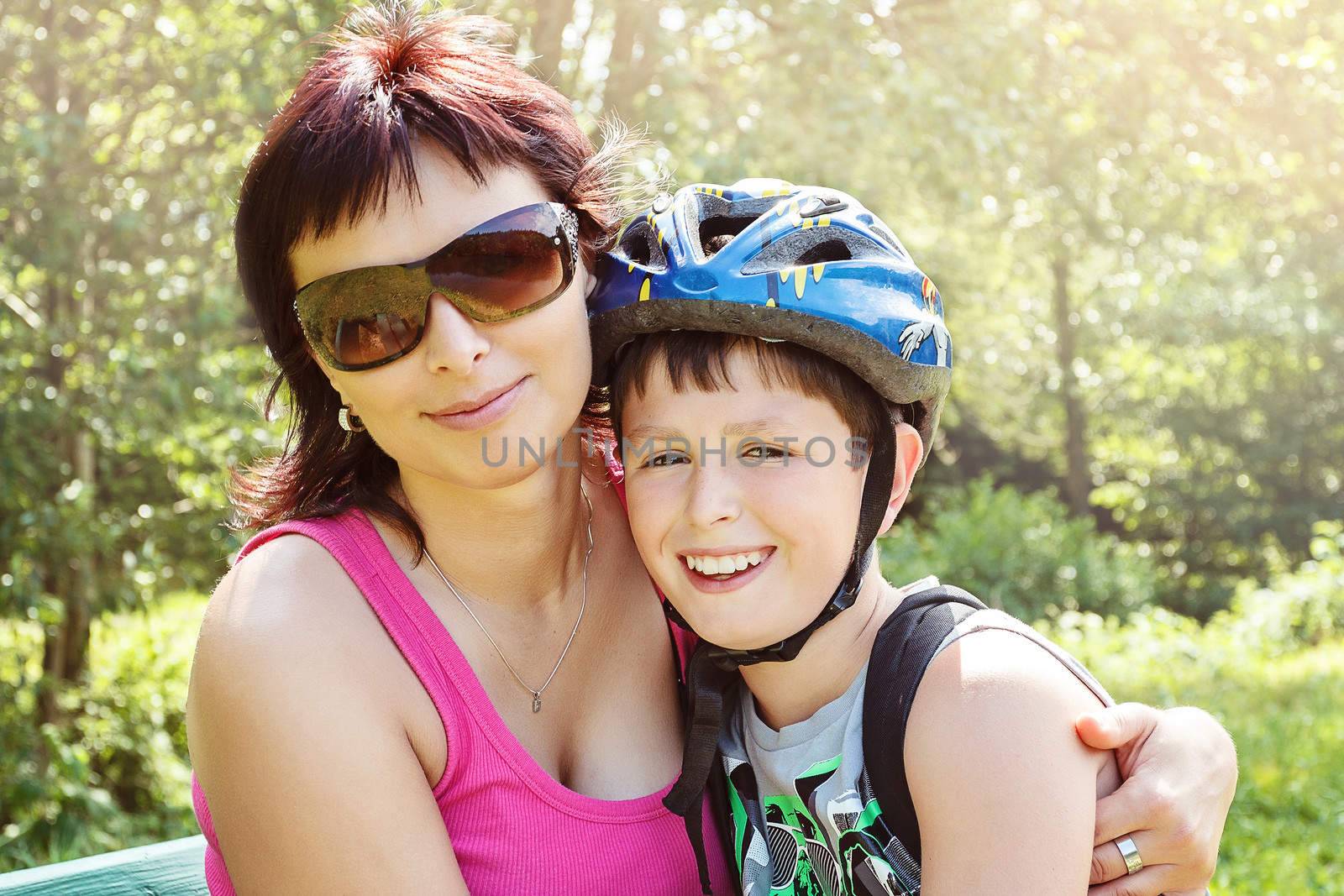 Mother and her son with bicycle helmet outdoor