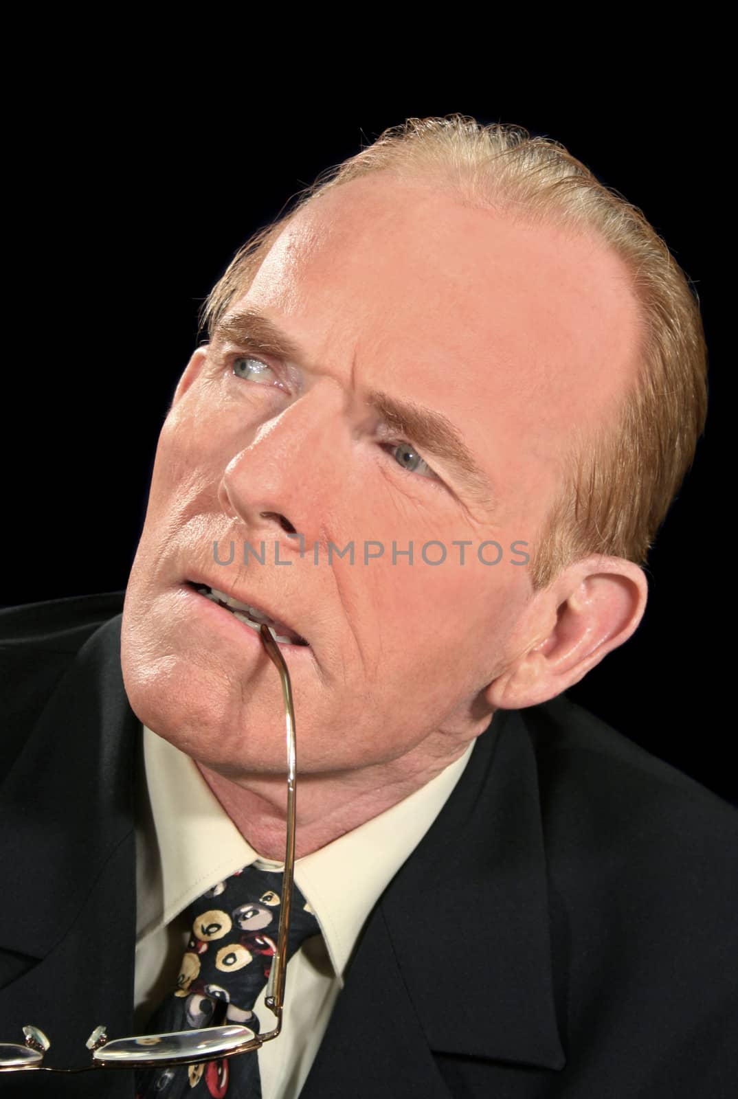 Businessman concentrating and listening intently with glasses.