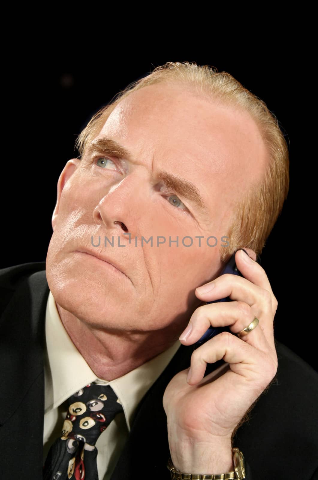 Businessman listening intently on his cell phone.