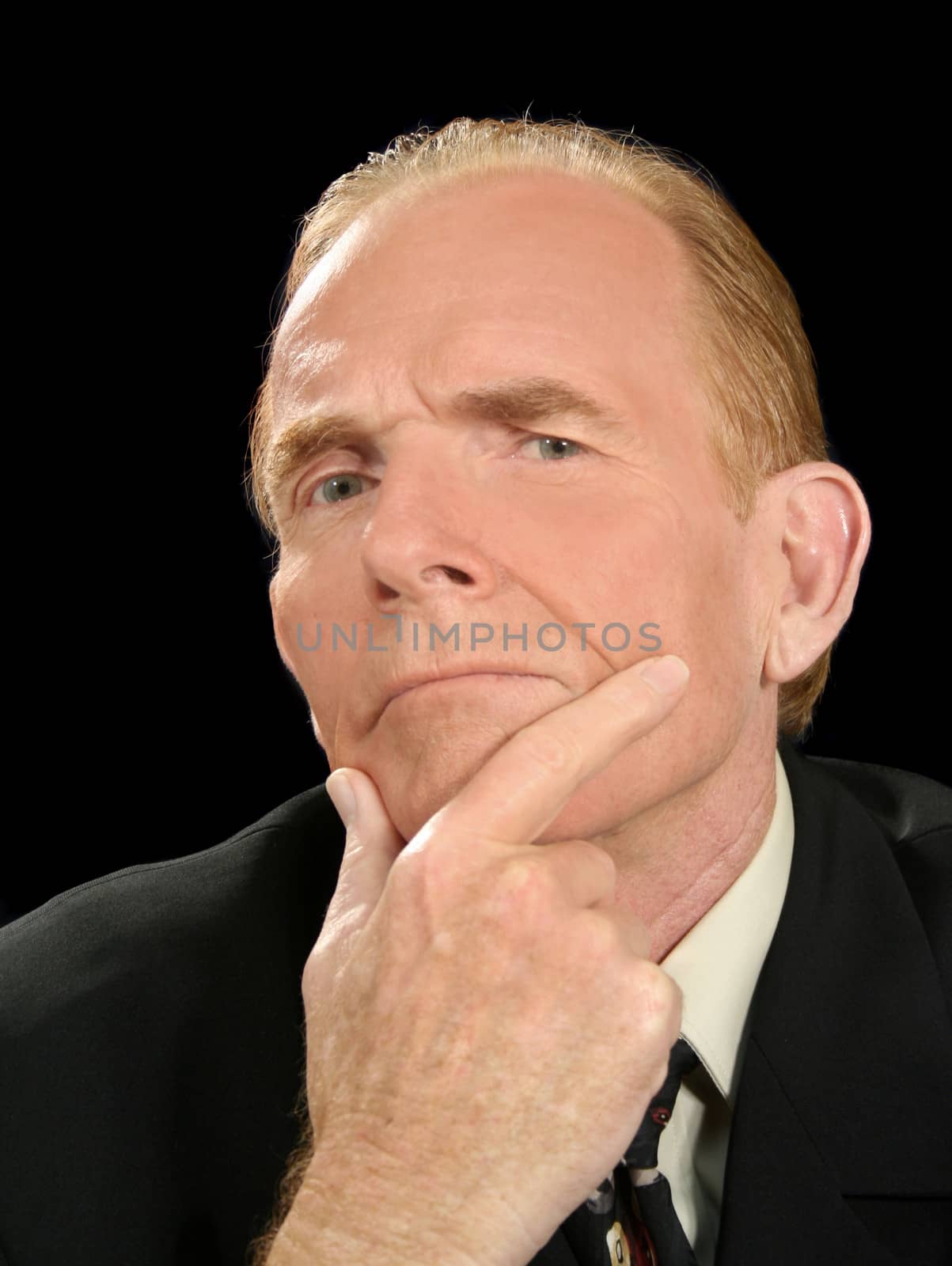 Businessman pondering over a decision.