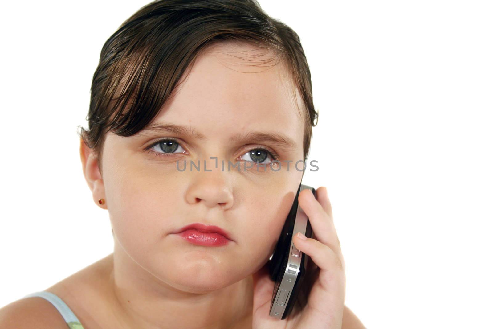 Little girl listening intently on her cell phone.