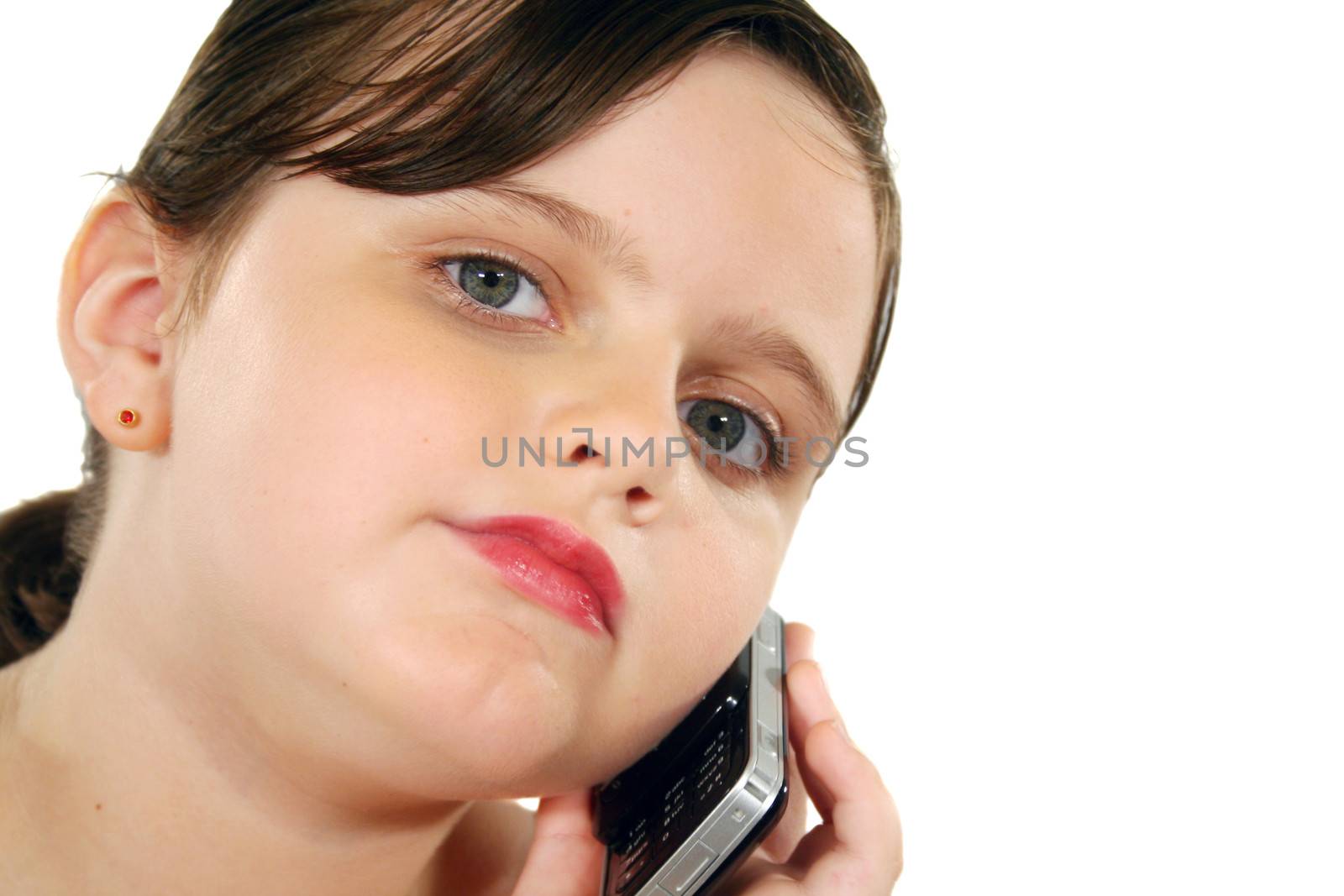 Little girl listening intently on her cell phone.