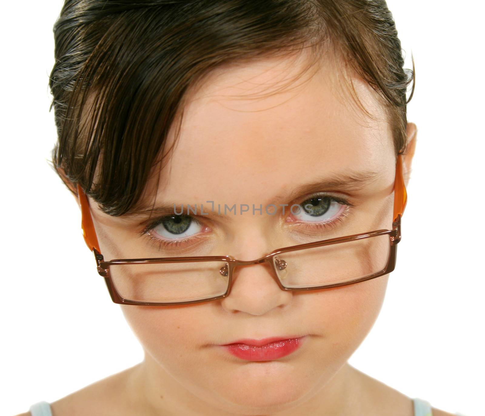 Little girl with piercing eyes looking over her glasses.