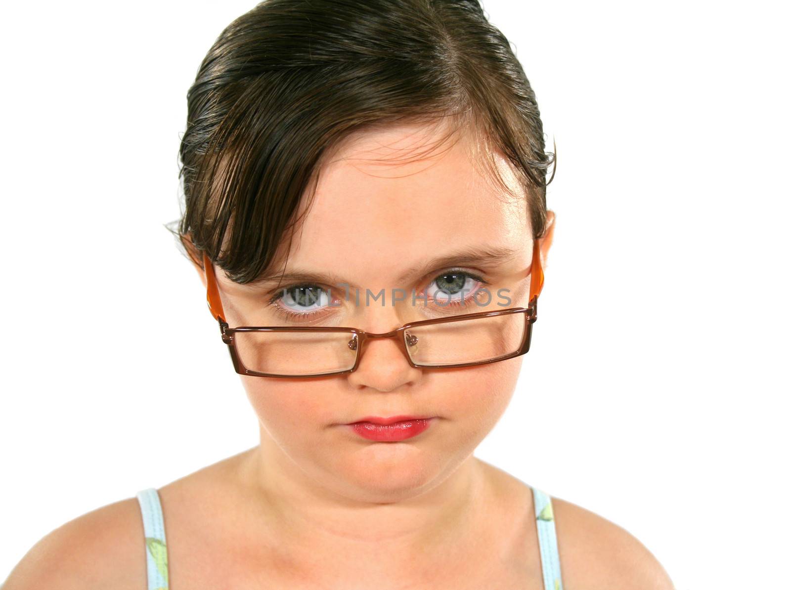 Close up of a little girl with glasses with serious look.