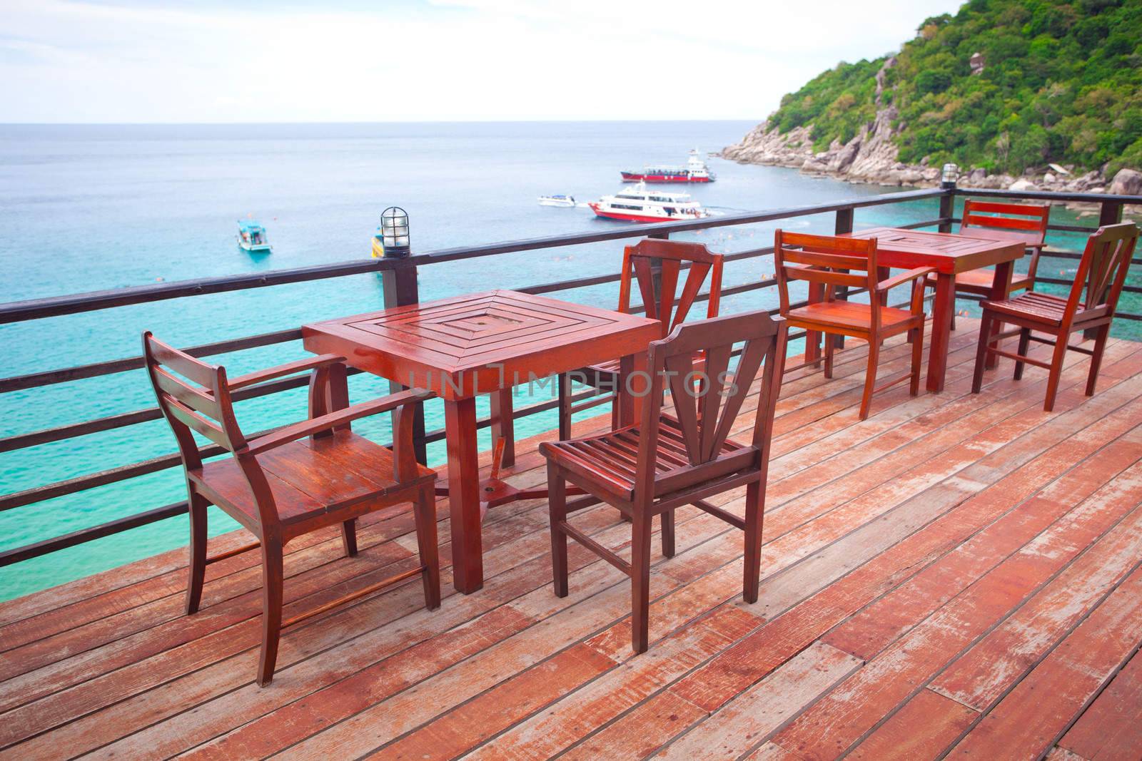 Chairs, table on the balcony of the restaurant near the sea