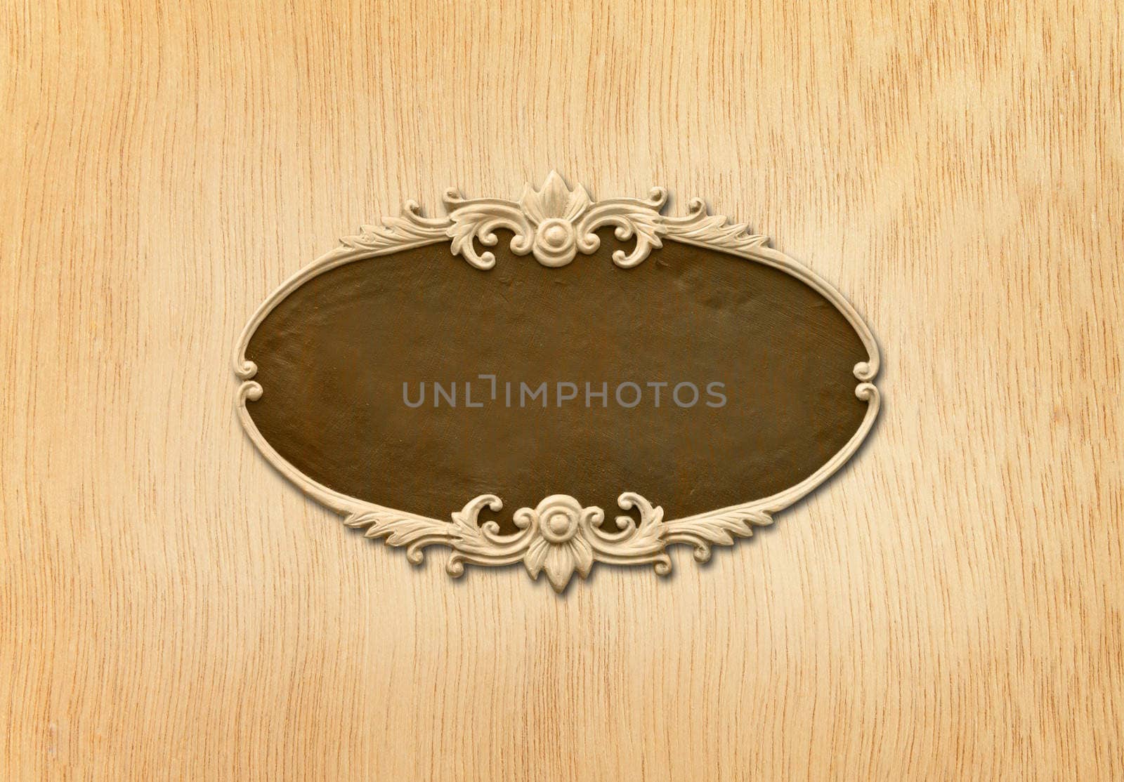 carved oval wood frame on wood background