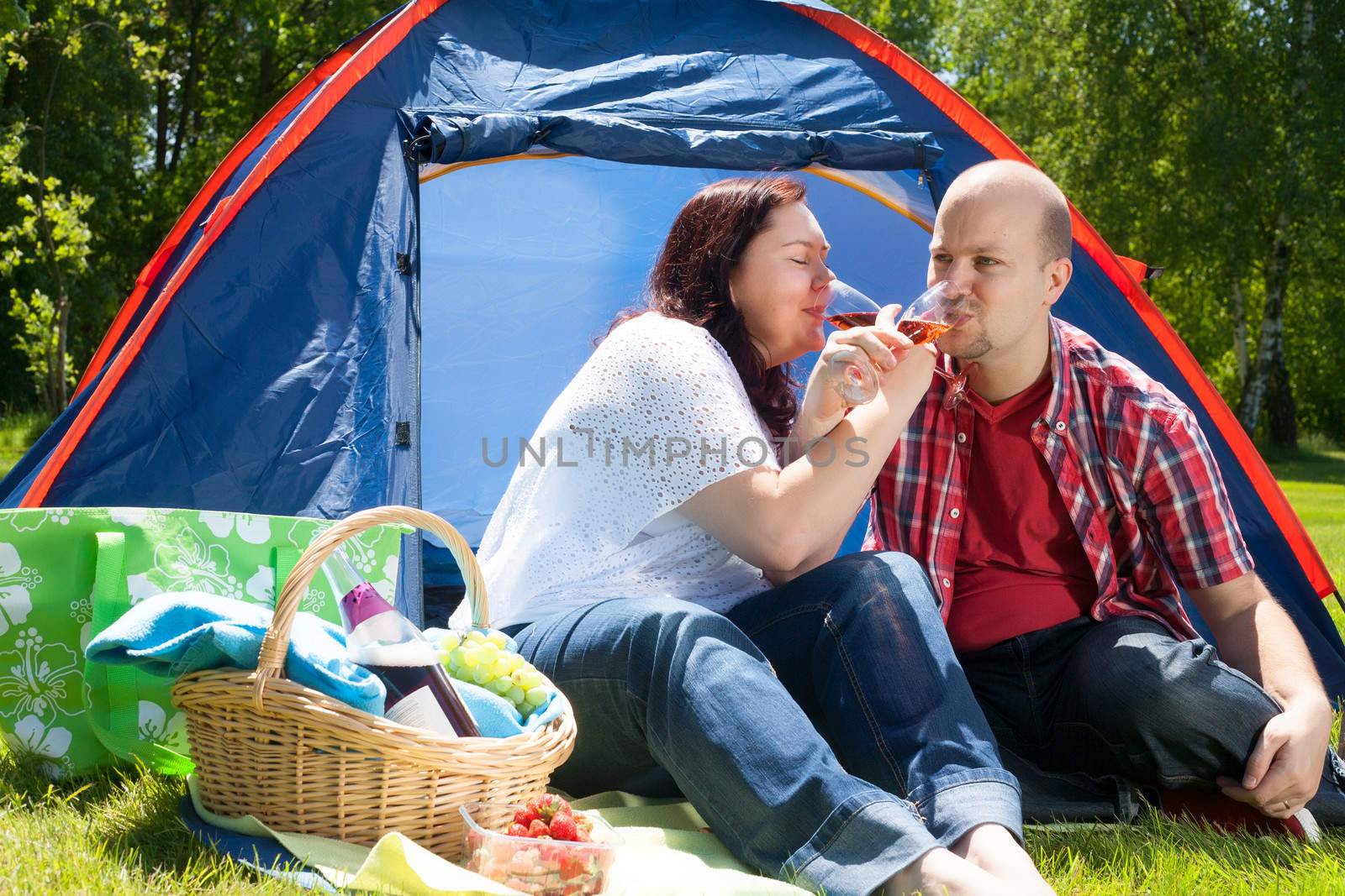 Happy young couple is relaxing on a camping