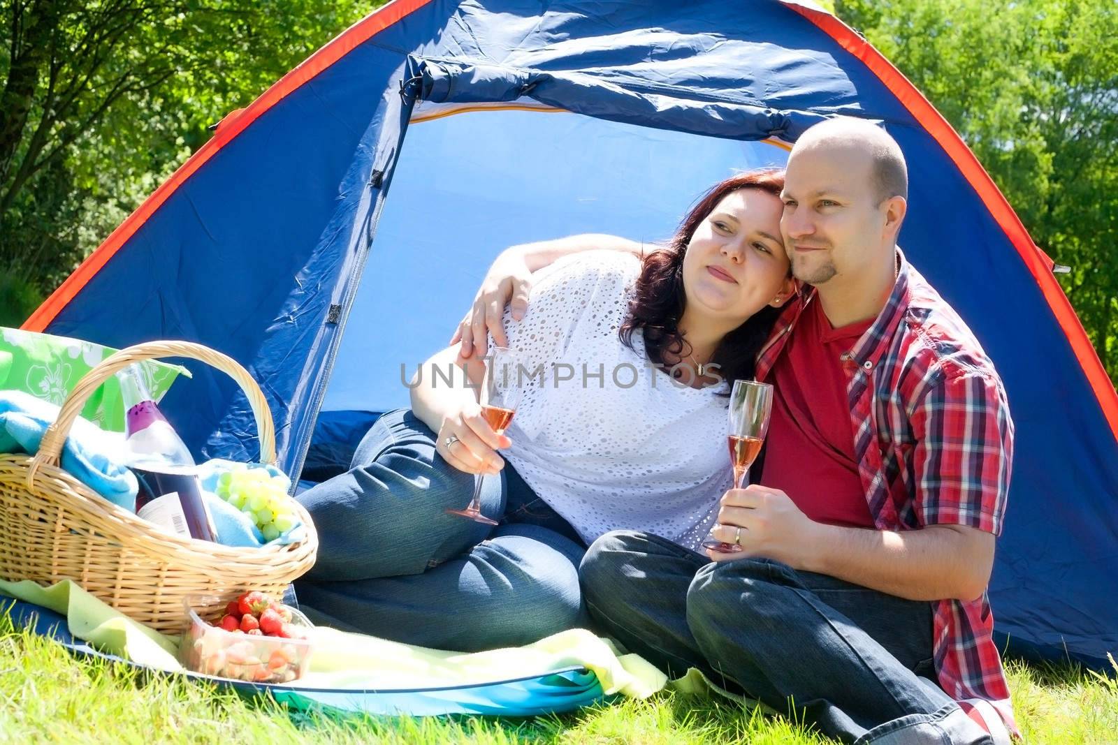 Happy young couple is relaxing on a camping