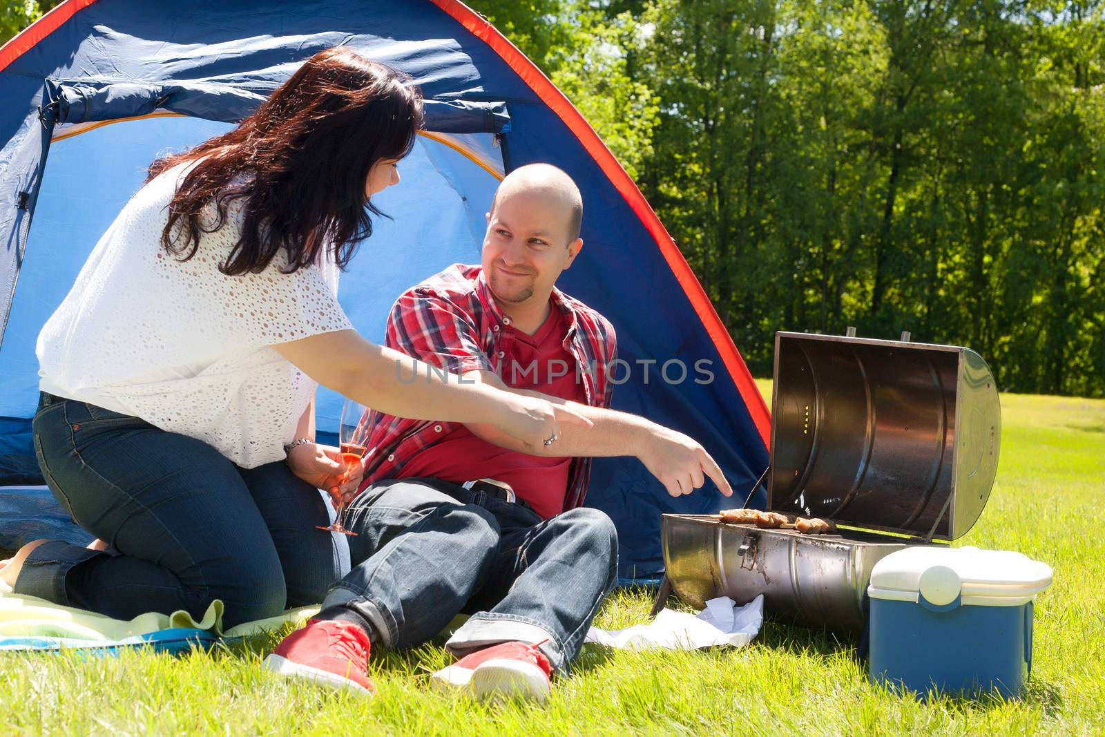 Happy young couple is relaxing on a camping