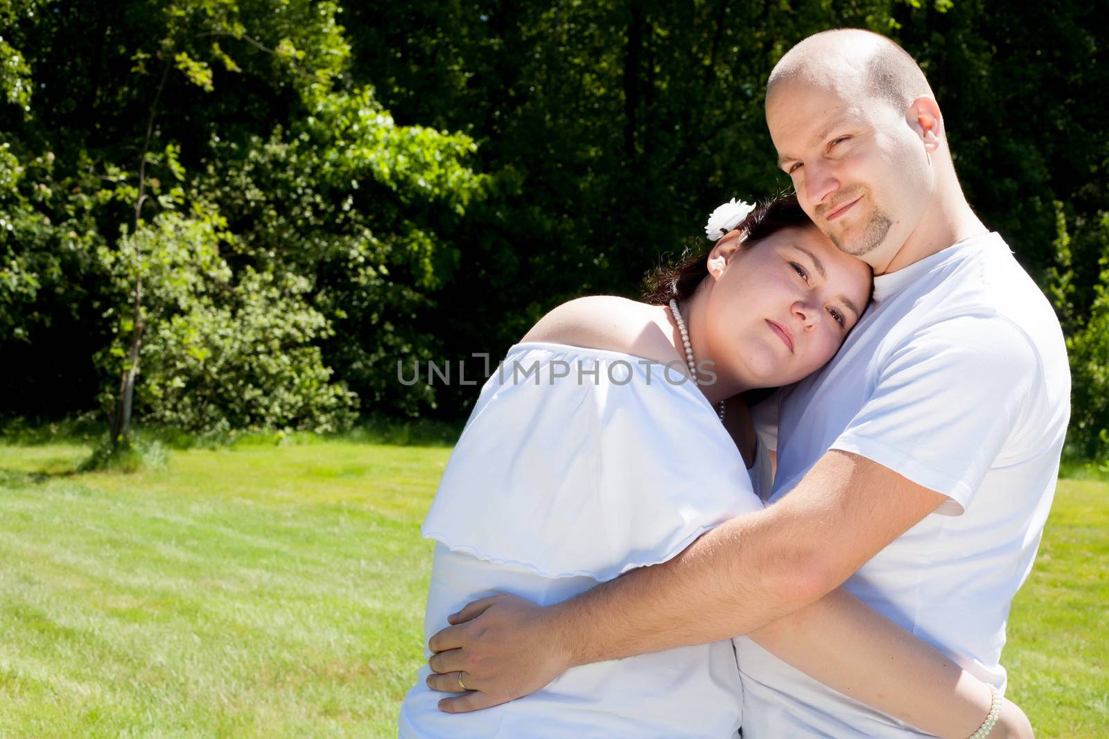 Happy young couple dressed white in the nature