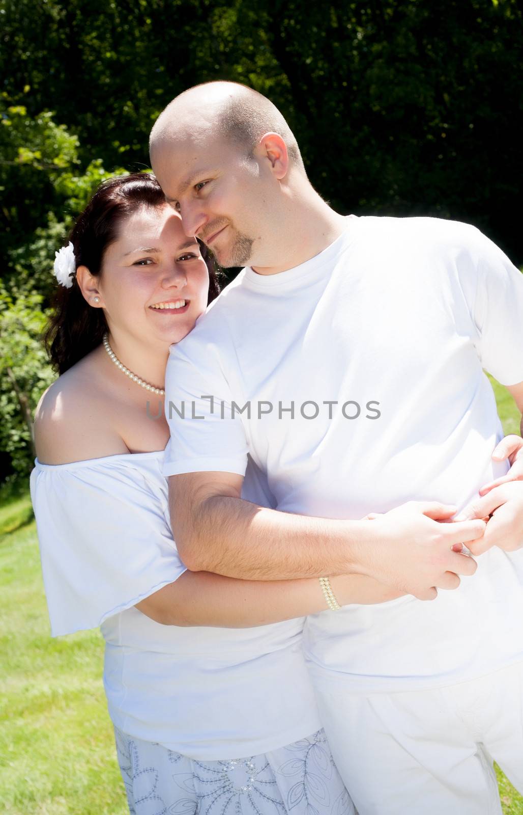 Happy young couple dressed white in the nature