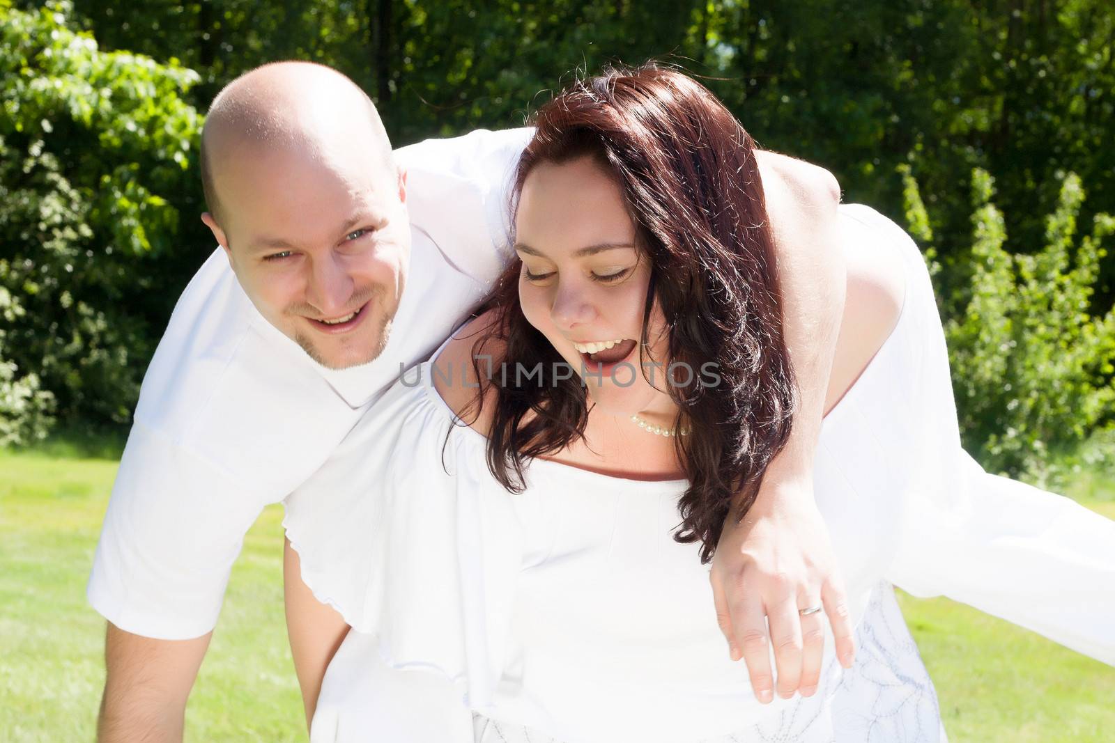 Happy young couple dressed white in the nature