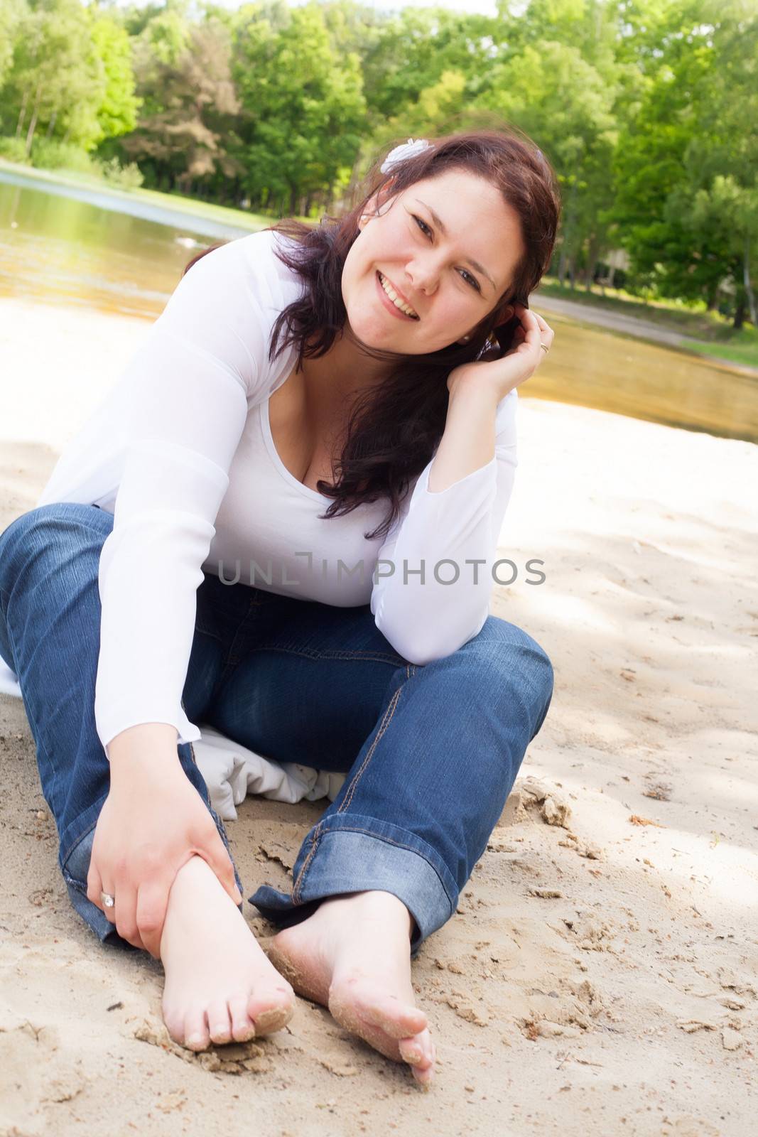 Happy young couple is having fun on a windy park beach