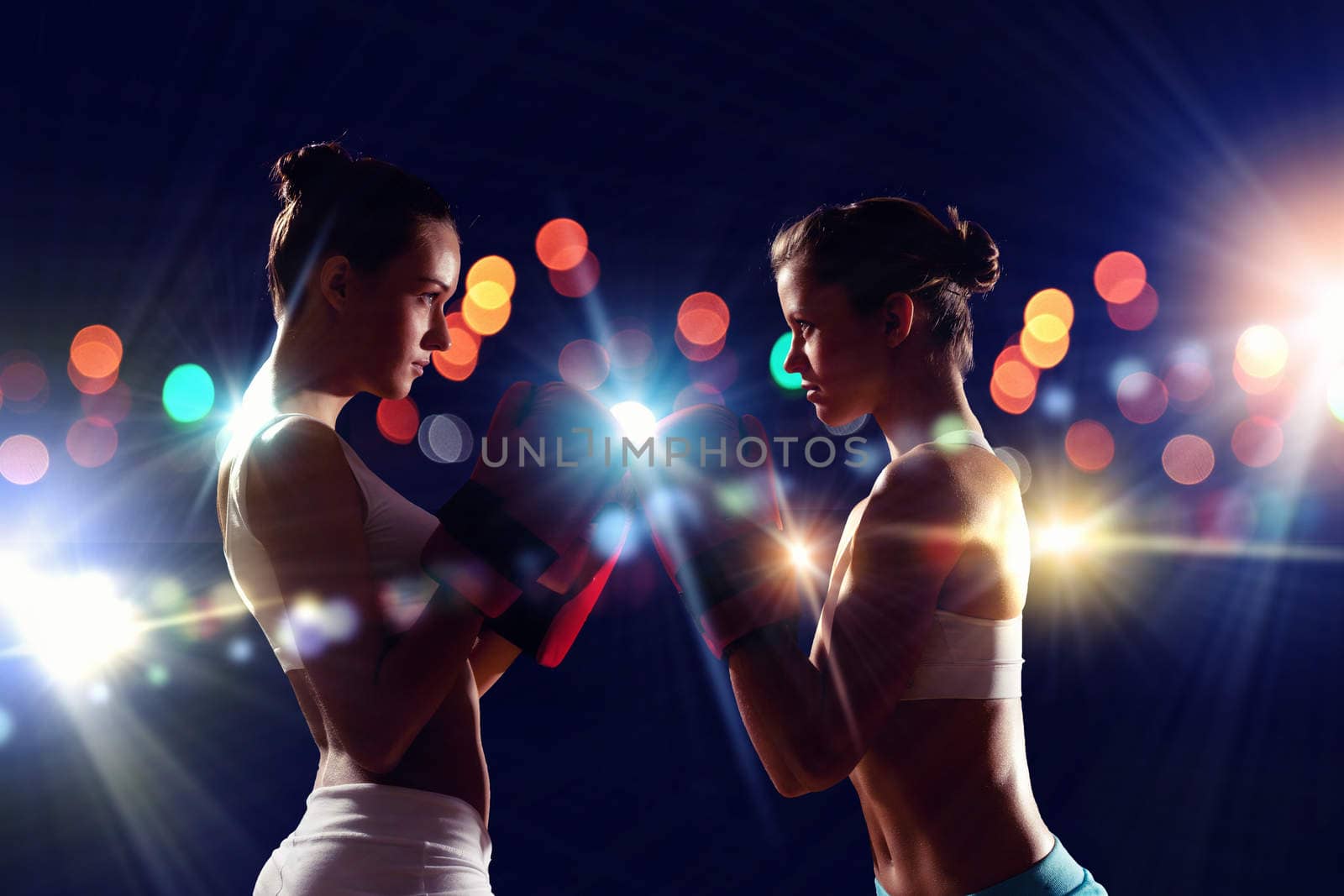 Two boxer women in gloves greet each other before fight