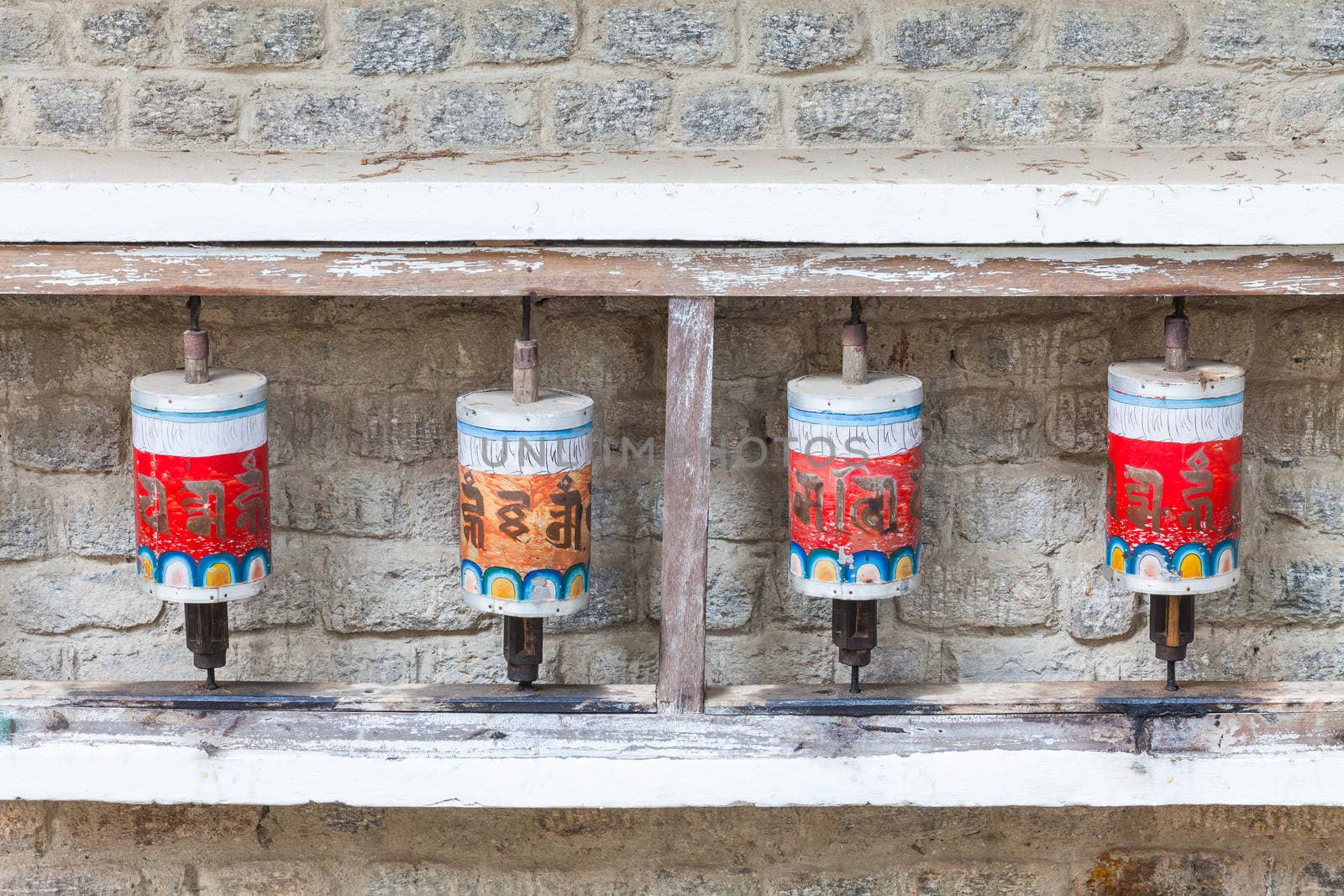 Buddhist prayer wheels in Tibetan monastery with written mantra, Yoksom, Sikkim, India.