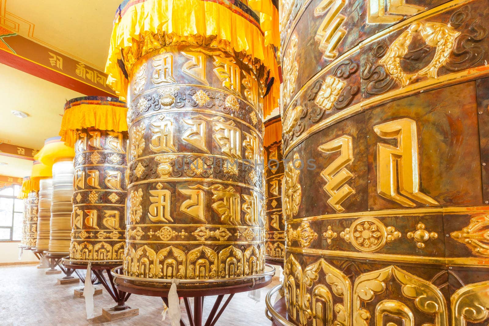 Buddhist prayer wheels in Tibetan monastery with written mantra, Yoksom, Sikkim, India.