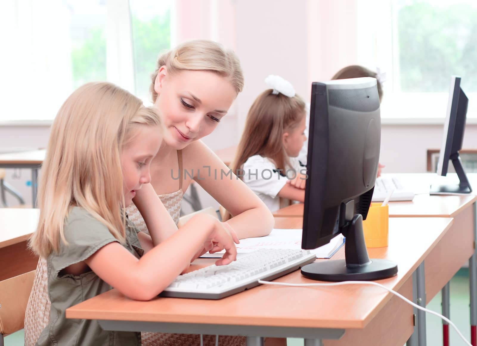 teacher explains the task schoolgirl at the computer, the new technologies in education