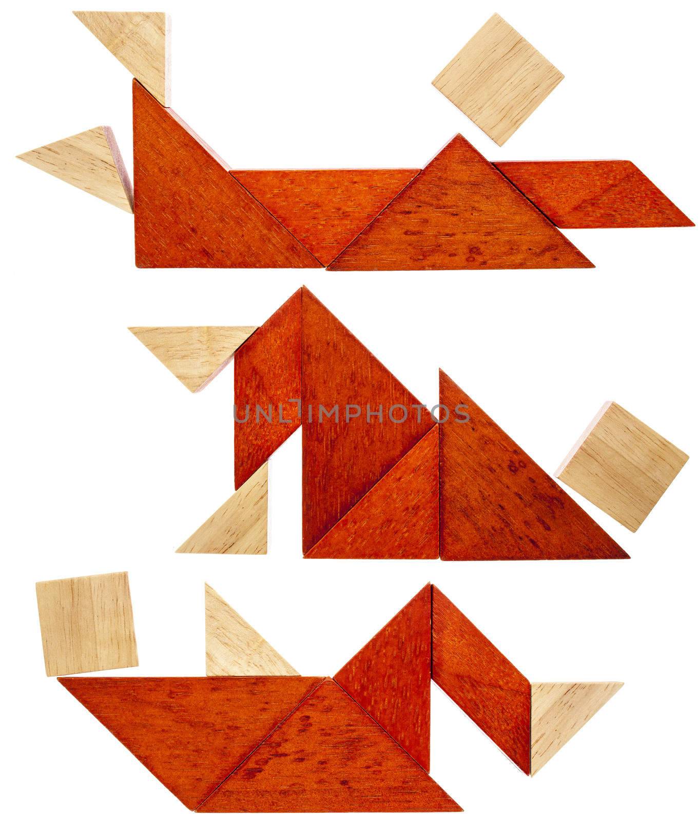 three abstract figures lying down and resting  built from seven tangram wooden pieces, a traditional Chinese puzzle game