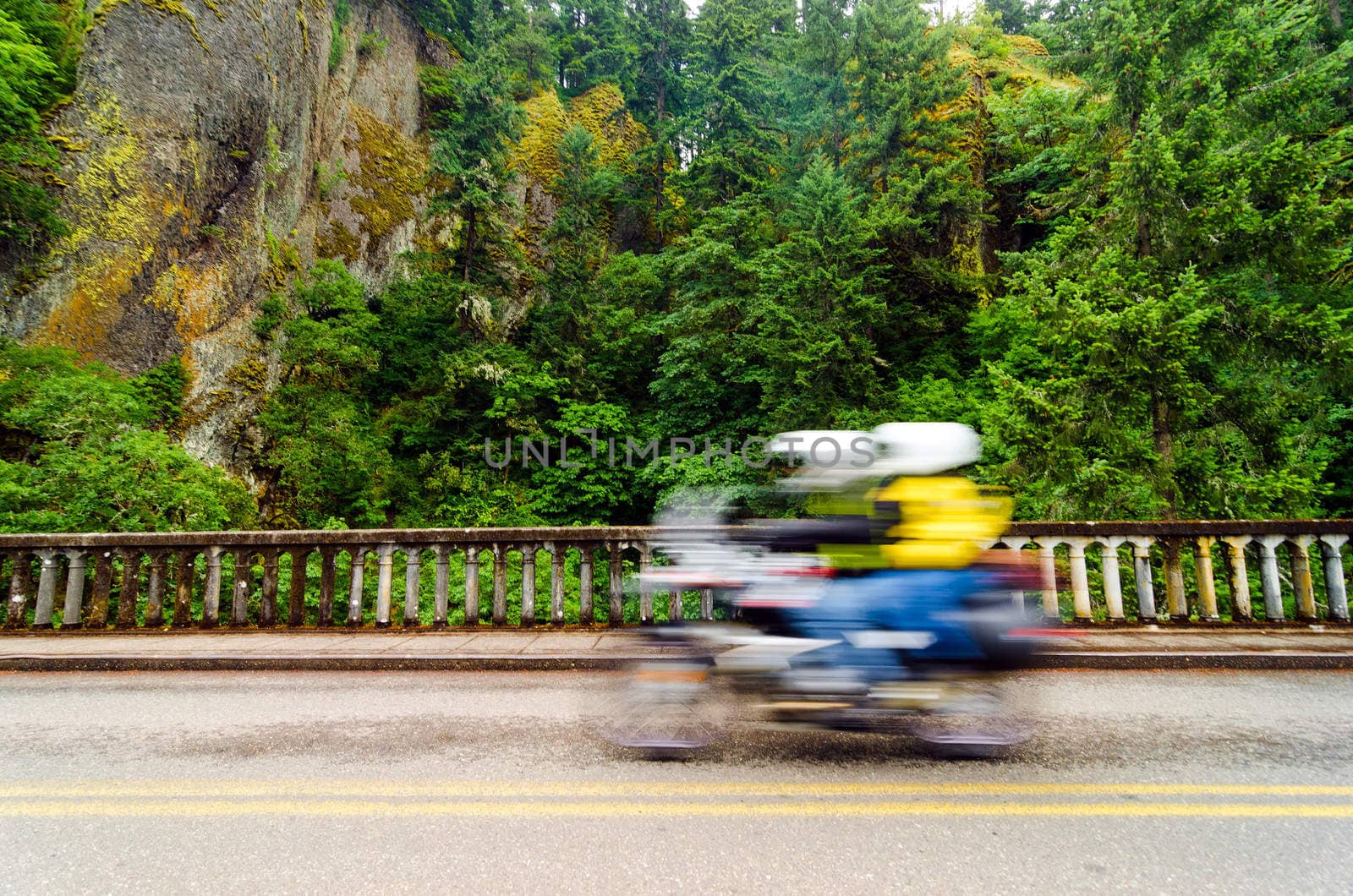 A motorycle passing by on the scenic highway in the Columbia River Gorge in Oregon