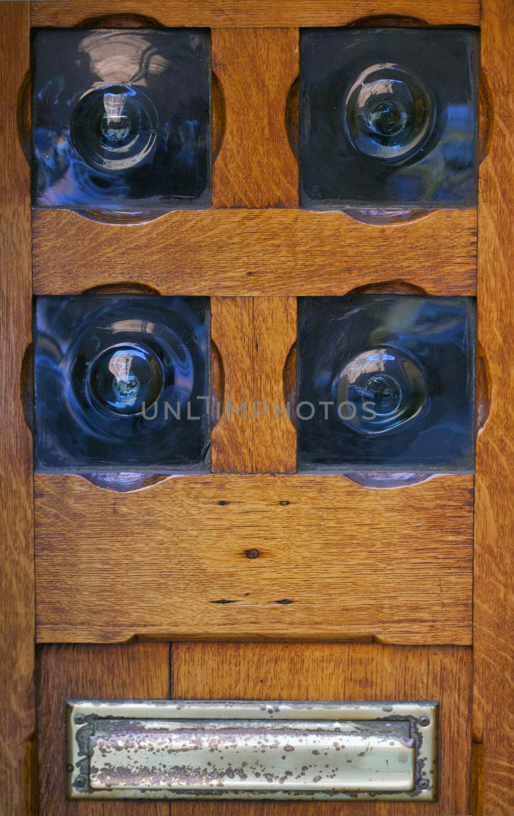 Old wooden door with decoration of blue glass.