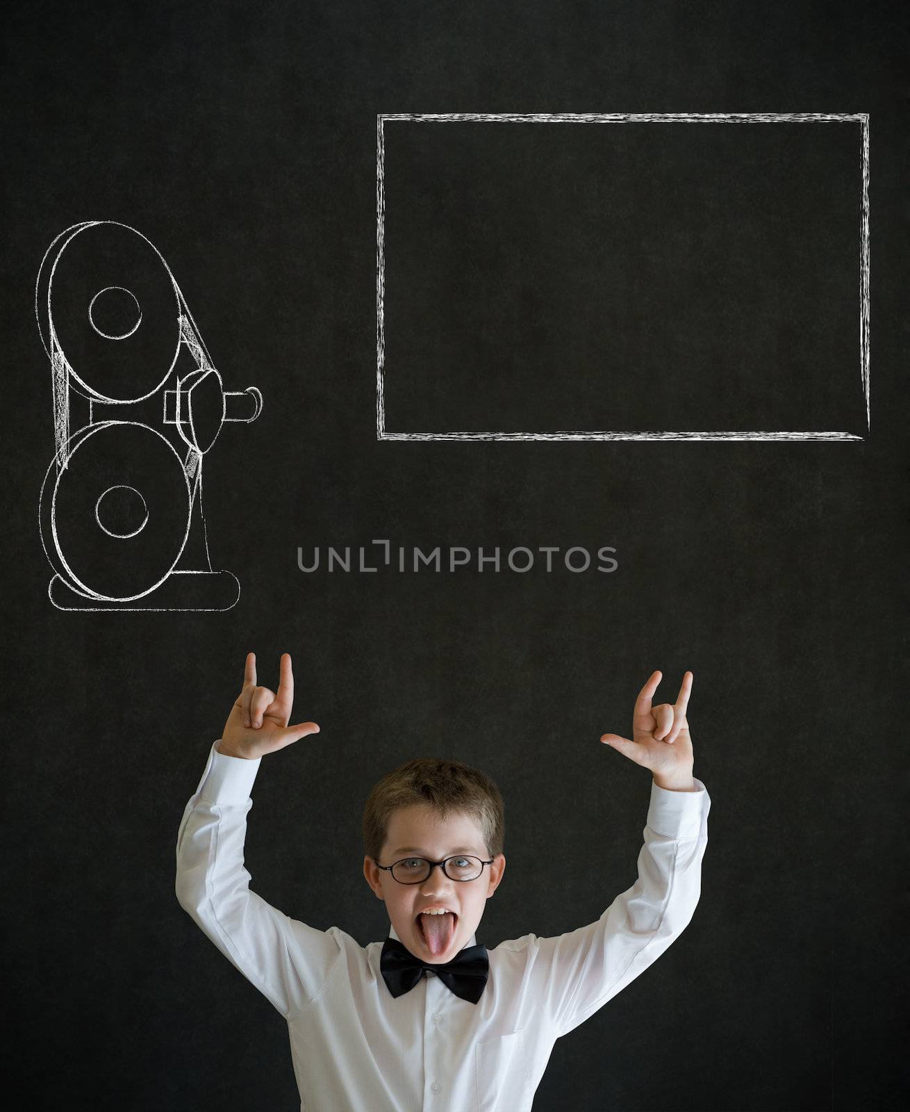 Knowledge rocks boy dressed up as business man with retro chalk film projector on blackboard background