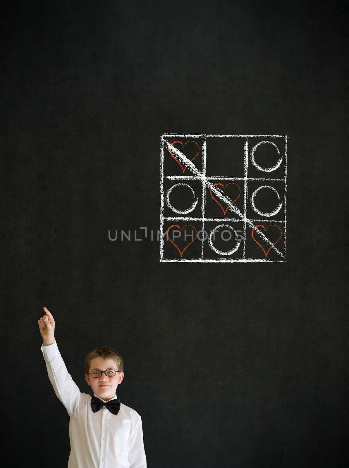 Hand up answer boy dressed up as business man with chalk tic tac toe love valentine concept on blackboard background