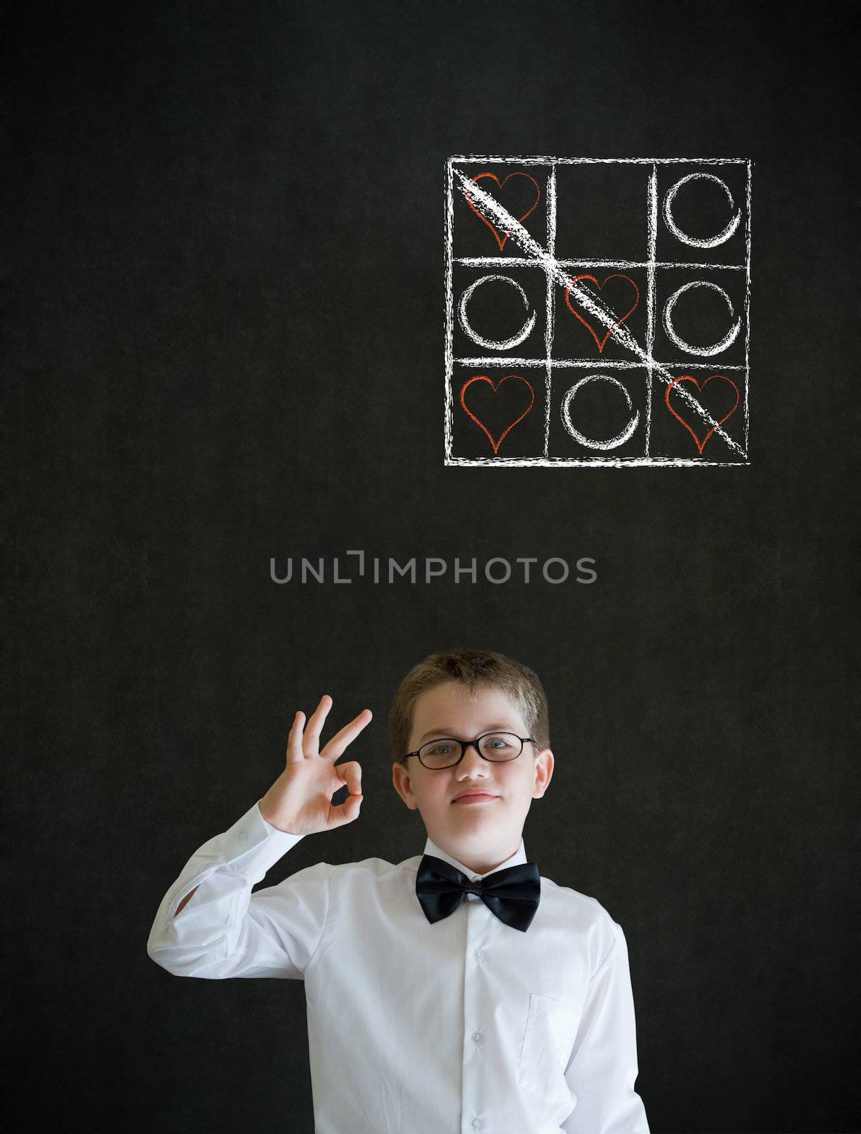 All ok or okay sign boy dressed up as business man with chalk tic tac toe love valentine concept on blackboard background