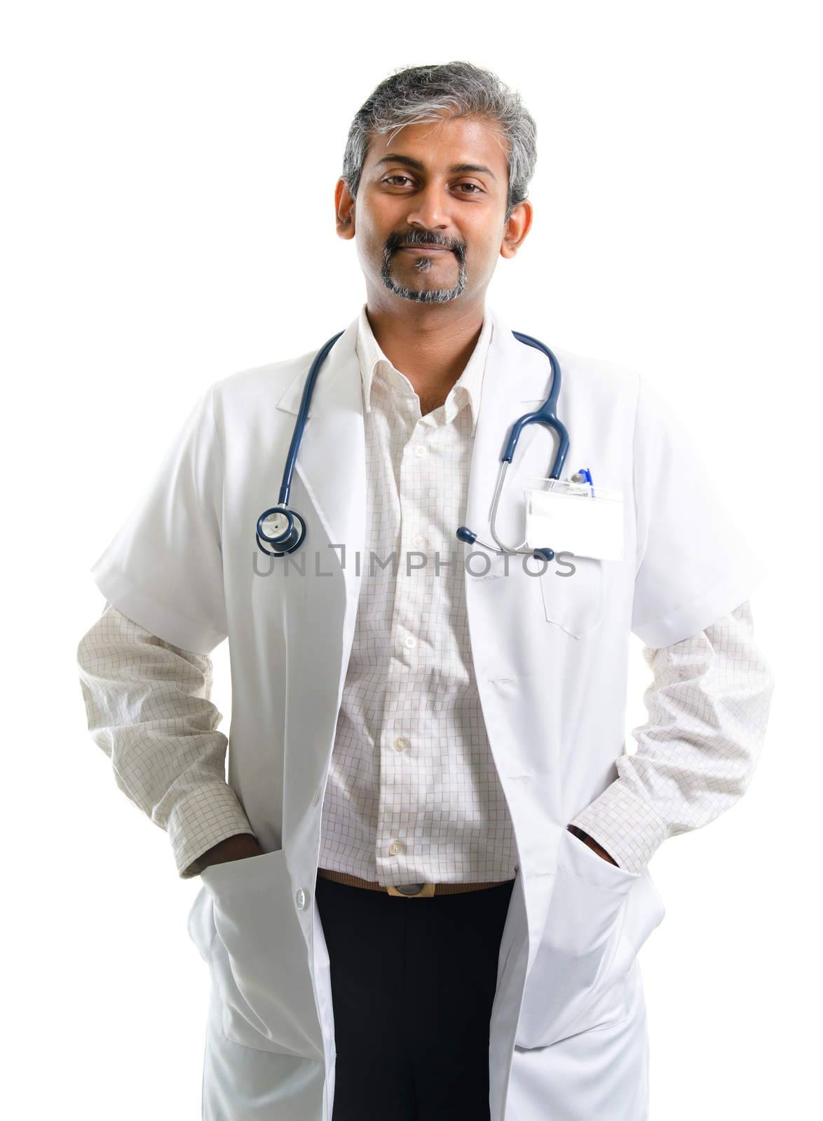 Indian doctor. Mature Indian male medical doctor standing isolated on white background. Handsome Indian model portrait.