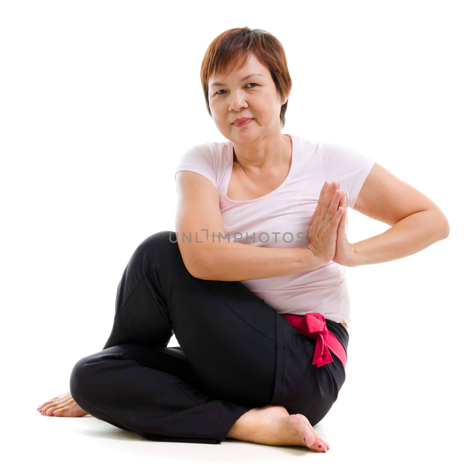 Asian senior woman practicing yoga, isolated on white background.
