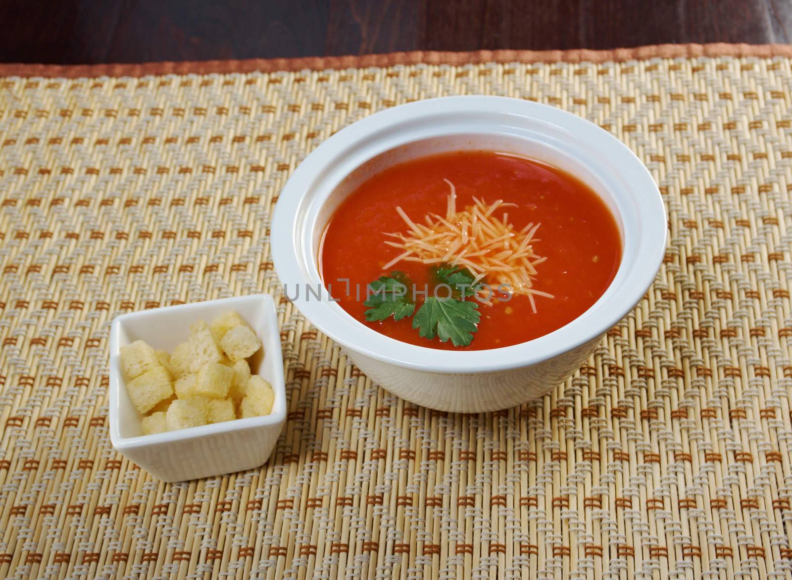 Thick and hearty tomato soup with basil.closeup