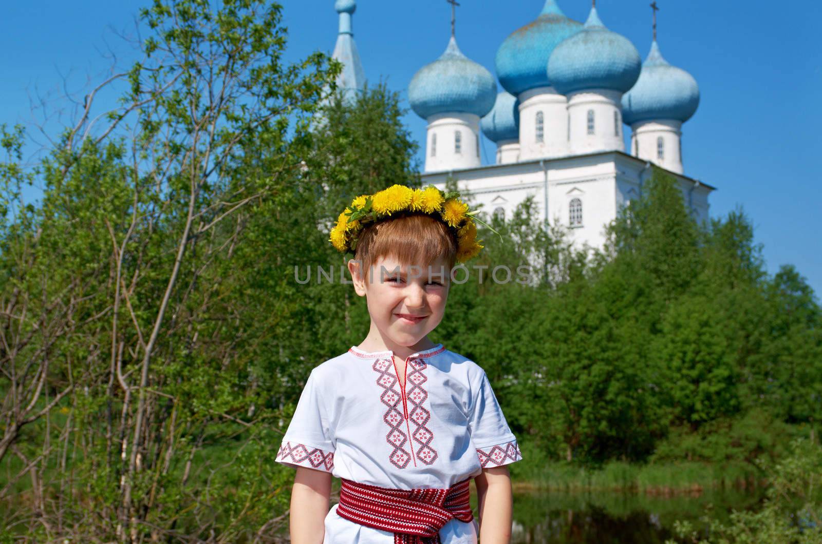 Russian little boy  on a orthodox church background.