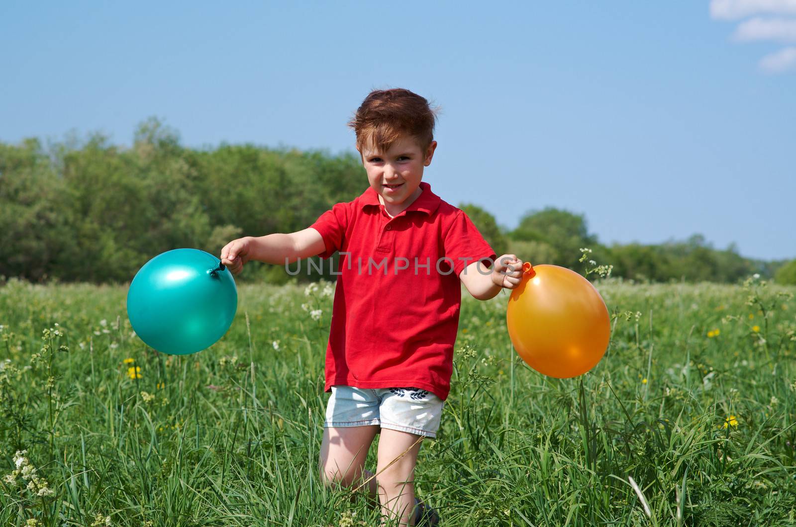 small boy with colorful  air balloon outdoor