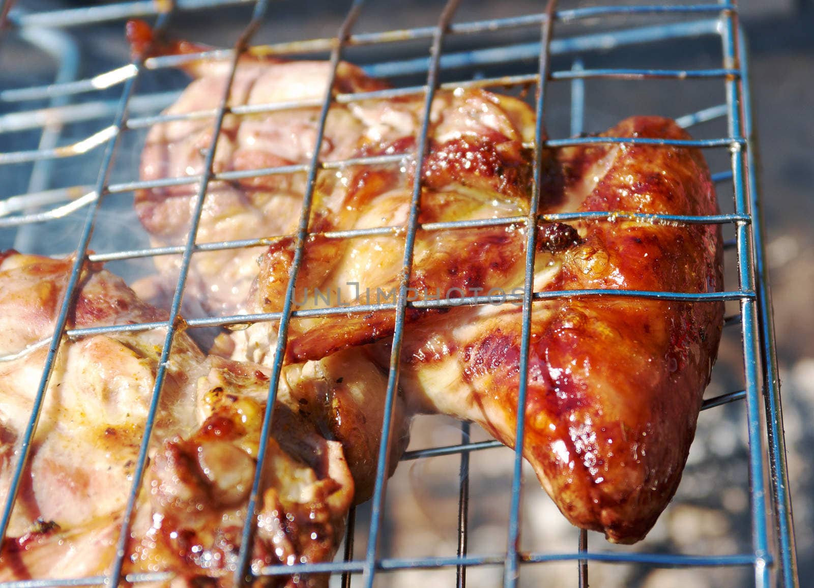 barbecue.chicken on the grill with flames