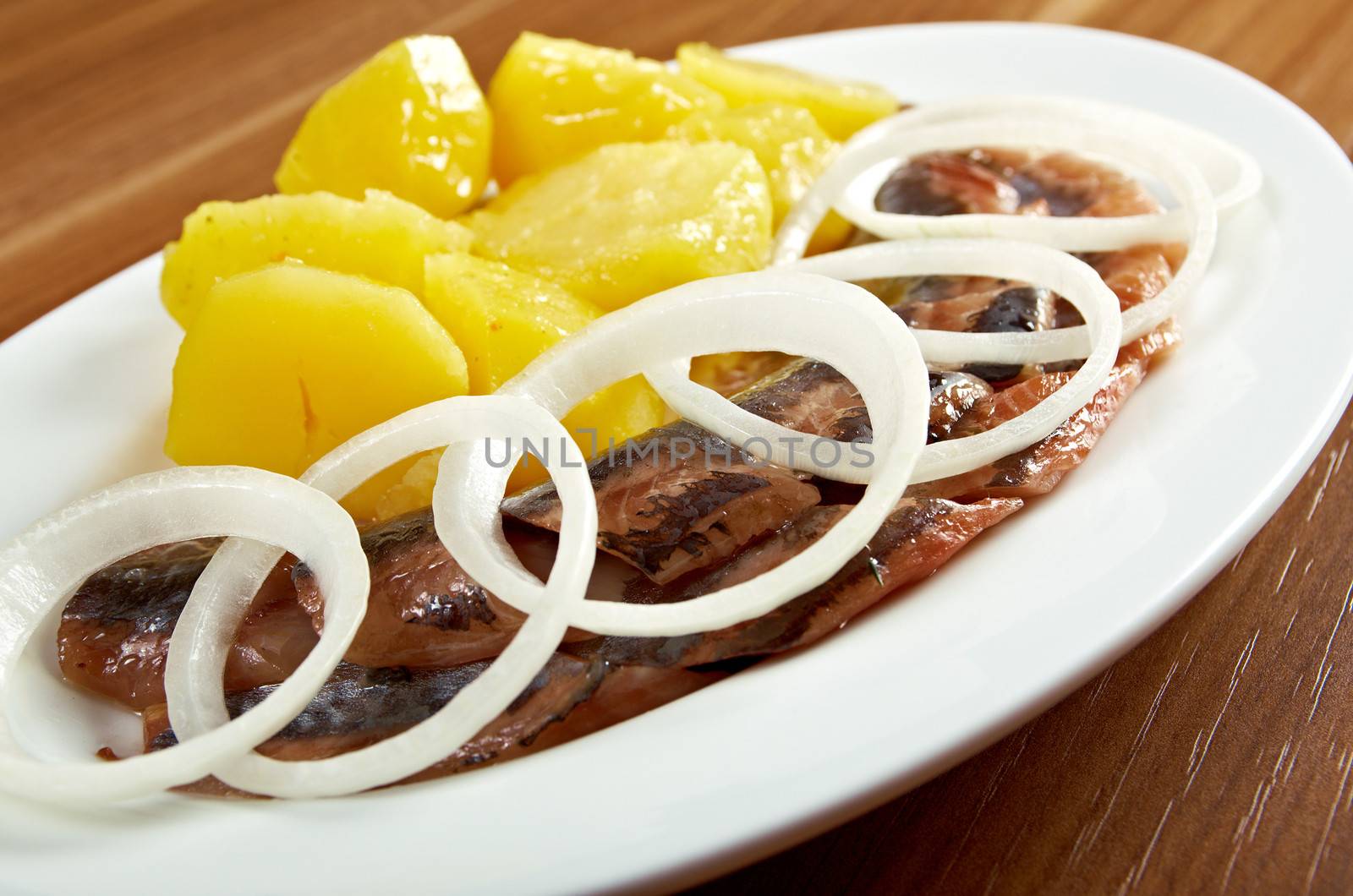 herring fish fillets with potato and onion